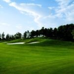 Golf Ball Below Feet: The Setup And Swing Changes You Need